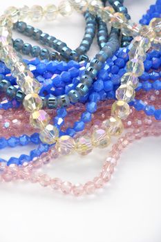 Mix of color faceted glass sparkle beads. Materials for creative work on white background.