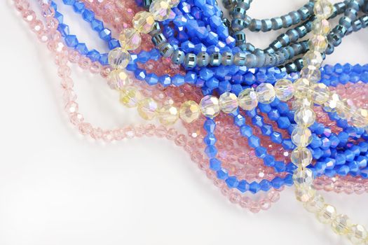 Mix of color faceted glass sparkle beads. Materials for creative work on white background.