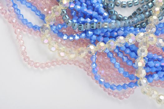 Mix of color faceted glass sparkle beads. Materials for creative work on white background.