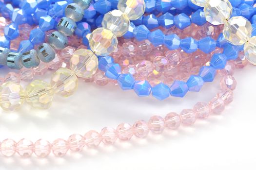 Mix of color faceted glass sparkle beads. Materials for creative work on white background.