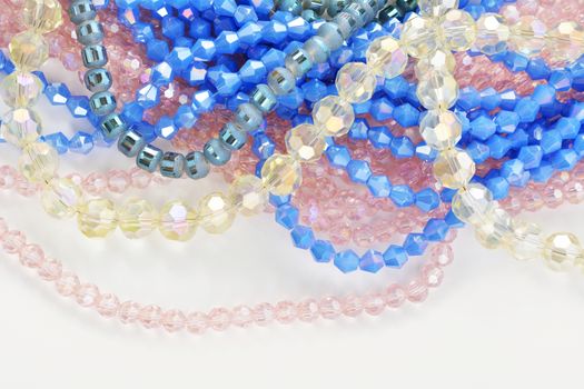 Mix of color faceted glass sparkle beads. Materials for creative work on white background.