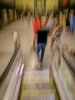 bike of people in blurry movement on mechanical ladder of metro station