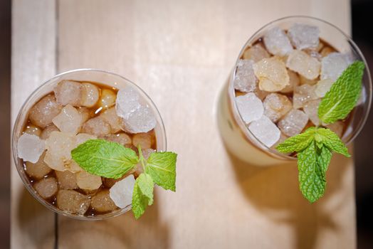 two glasses of mojito with ssu ices seen zenital flat on wooden board