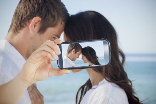 Composite of Couple taking selfie on smartphone