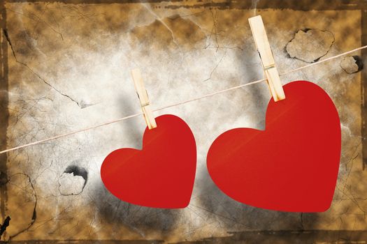 Hearts hanging on a line against brown background