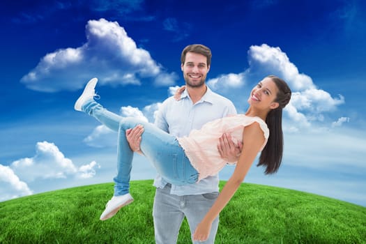 Attractive young couple having fun against green field under blue sky