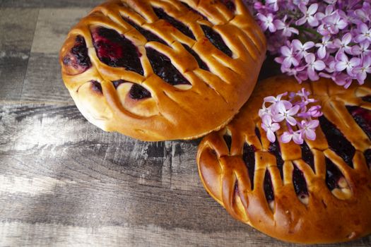 Blackcurrant yeast cake with fresh lilac, traditional russian bun
