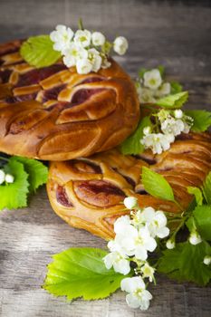 Braided bread with strawberry and spring flowers, vertical image