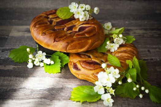 whole strawberry jam tart decorated with white spring flowers