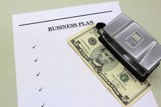 Money, documents, business plan and office punch