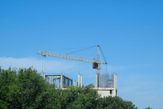 construction of multi-storey residential buildings. Tower cranes at a construction site.