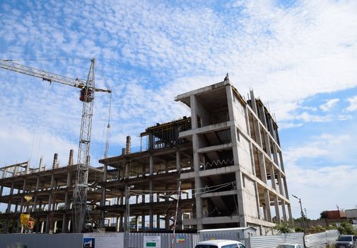 construction of multi-storey residential buildings. Tower cranes at a construction site.