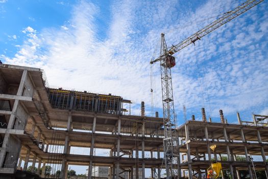 construction of multi-storey residential buildings. Tower cranes at a construction site.