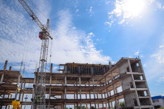 construction of multi-storey residential buildings. Tower cranes at a construction site.