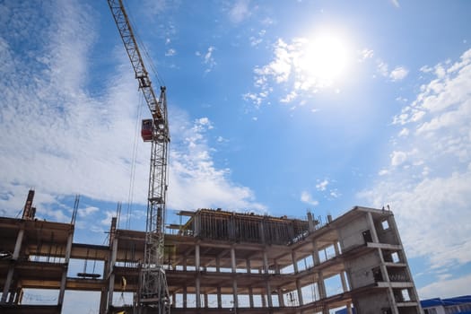 construction of multi-storey residential buildings. Tower cranes at a construction site.