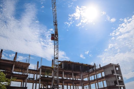 construction of multi-storey residential buildings. Tower cranes at a construction site.