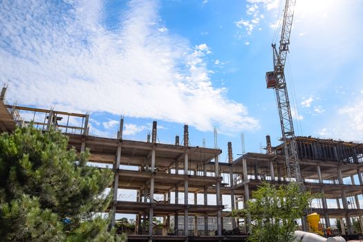 construction of multi-storey residential buildings. Tower cranes at a construction site.