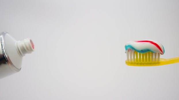 toothbrush with toothpaste on a white background