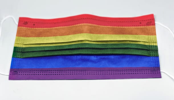 surgical mask with the rainbow flag of gay pride. Pandemic covid-19 and preventive measures to counter the spread of the virus