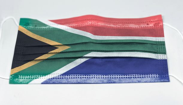 surgical mask with the national flag of South Africa printed. Pandemic covid-19 and preventive measures to counter the spread of the virus