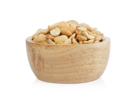 Roasted peanuts in wooden bowl on white background, healthy food concept