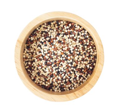 Quinoa in wooden bowl isolated on white background