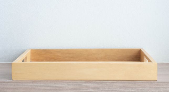 Empty wooden tray on table background