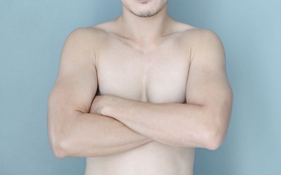 Closeup asian man crossed hand with blue background, health care concept