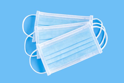 Medical mask isolated on blue background for protect air polution or virus covid 19, health care concept
