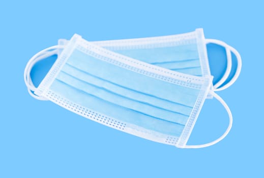 Medical mask isolated on blue background for protect air polution or virus covid 19, health care concept