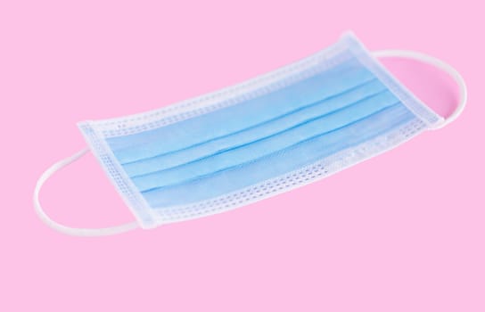 Medical mask isolated on pink background for protect air polution or virus covid 19, health care concept