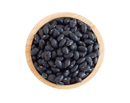 Closeup black beans seeds in wooden bowl on white background, healthy food concept