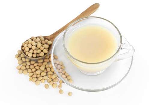 Soymilk in glass with soy beans in wooden spoon isolated on white backgroun, health care concept