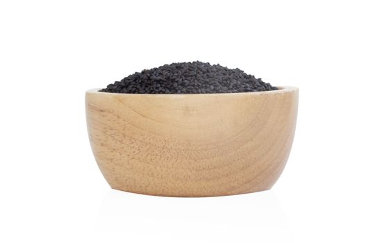 Closeup black sesame seeds in wooden bowl on white background, healthy food concept