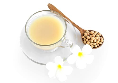 Soymilk in glass with soy beans in wooden spoon isolated on white backgroun, health care concept