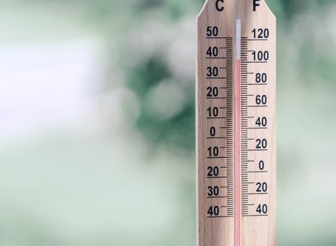 Close up hand holding thermometer with hot temperature