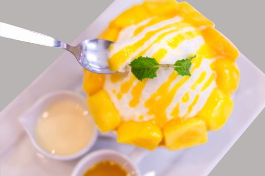 Close up mango bing su with sauces in white plate