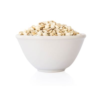 Job's tears in ceramic bowl on white background, healthy food concept