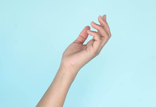 Woman hands holding something on blue background for product advertising concept
