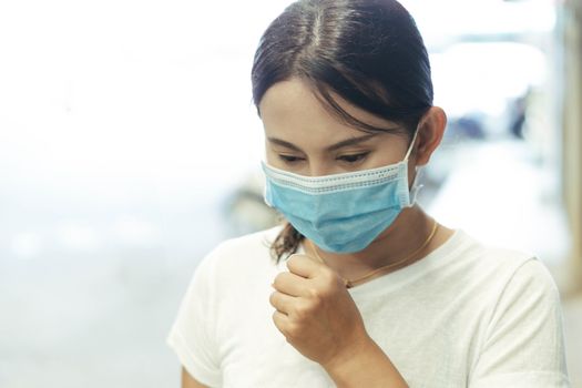 Closeup woman wearing face mask for protect air polution or virus covid 19, health care and medical concept