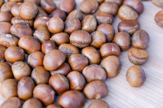 Closeup horse chestnuts on wooden table background, healthy food concept