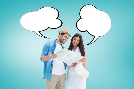 Happy hipster couple looking at map against blue vignette background