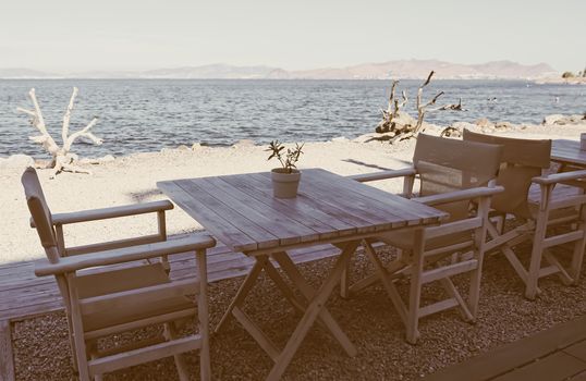 Empty restaurant by the Aegean sea and cruise boat, travel and nature, scene