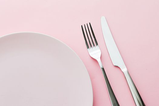 Empty plate and cutlery as mockup set on pink background, top tableware for chef table decor and menu branding design