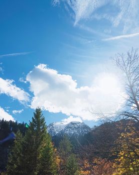 Beautiful nature of European Alps, landscape view of alpine mountains, lake and village on a sunny day, travel and destination scenery