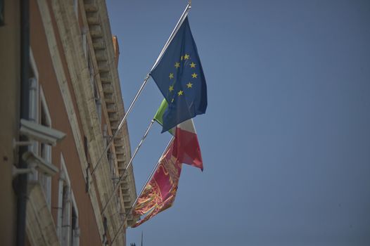 VENICE, ITALY 25 MARCH 2019: European and Italian flag on the building in Venice