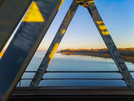 Beautiful sunrise over coast and trees in Swinoujscie seen from train bridge