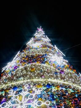 Colorful christmas tree with glowing decorations at Wroclaw market square