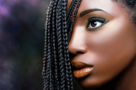 Macro close up african beauty face shot of young woman with braids. Professional make up fantasy portrait of attractive girl.
