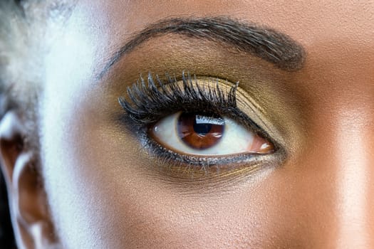 Extreme close up of african female eye with professional make up.